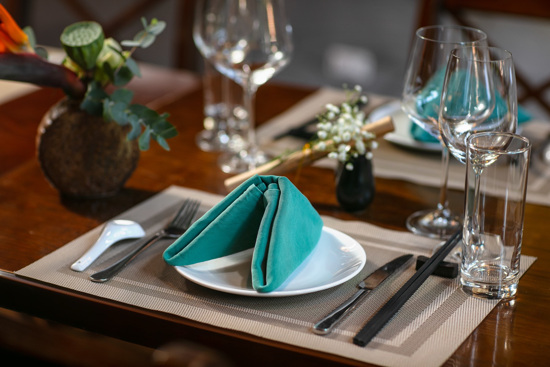 Place setting with folded teal napkin